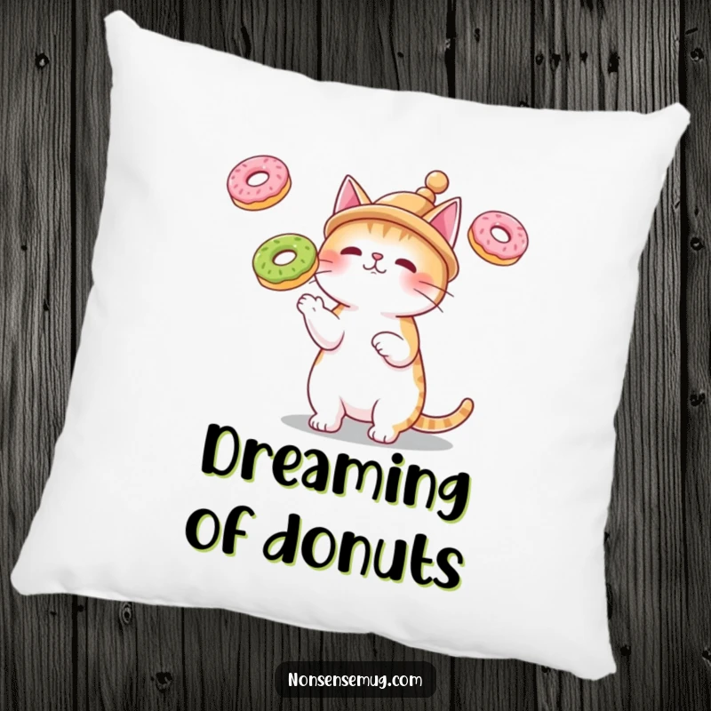 Funny pillow with a cat wearing a small hat, juggling three floating donuts, for humorous comfort and decor.