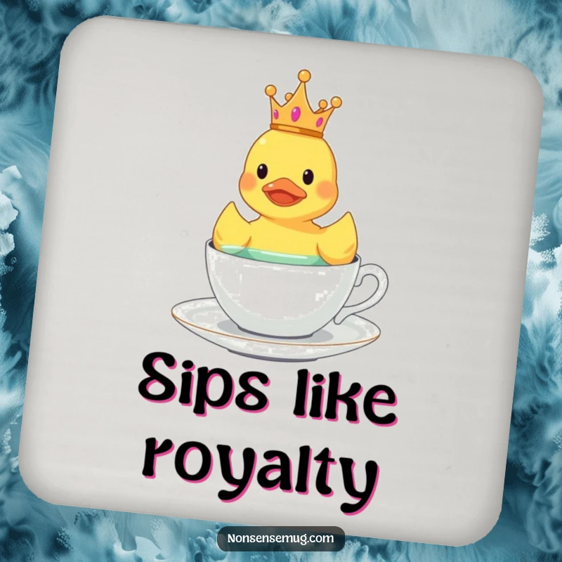 Funny rubber duck wearing a tiny crown, floating in a teacup, on a drink coaster.