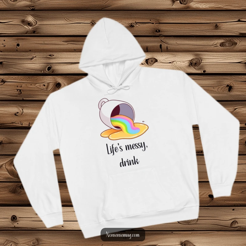 Funny coffee mug tipping over and spilling a rainbow, on a hoodie, keeping you warm and colorful.