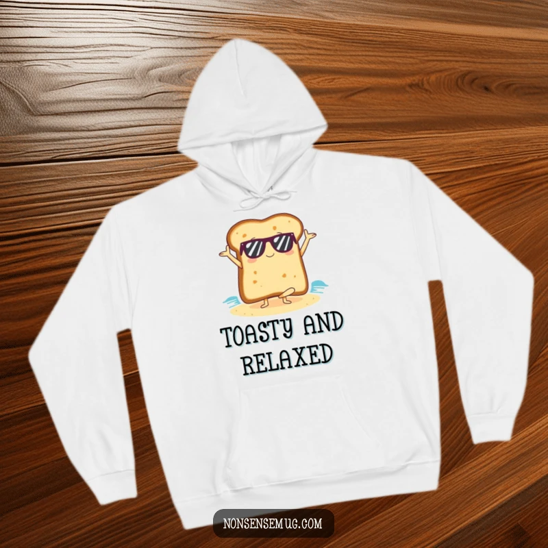 Funny slice of toast wearing sunglasses, doing yoga on a beach, designed for a cozy hoodie.