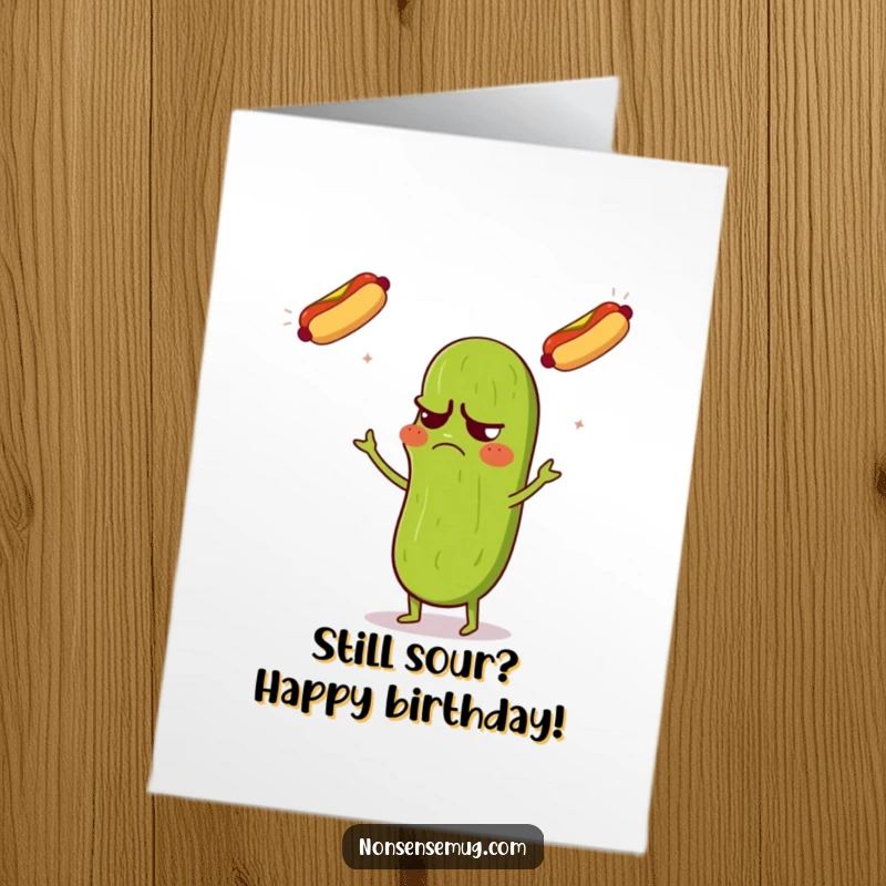 Funny Free Printable Birthday Card: Grumpy pickle confusedly juggling three flying hot dogs, celebrating a birthday.