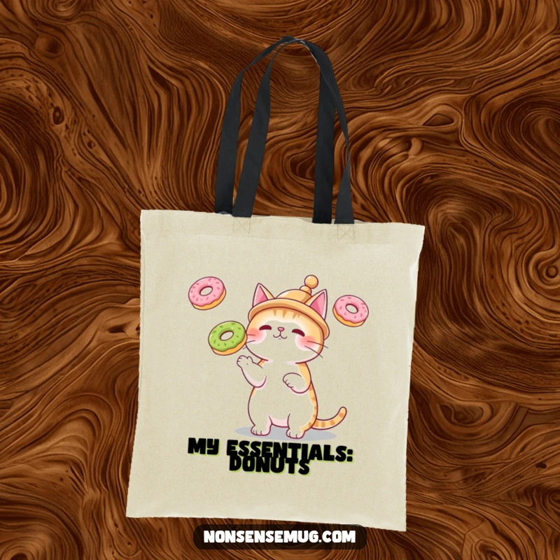 Funny tote bag with a cat wearing a small hat, juggling three floating donuts, perfect for carrying items humorously.